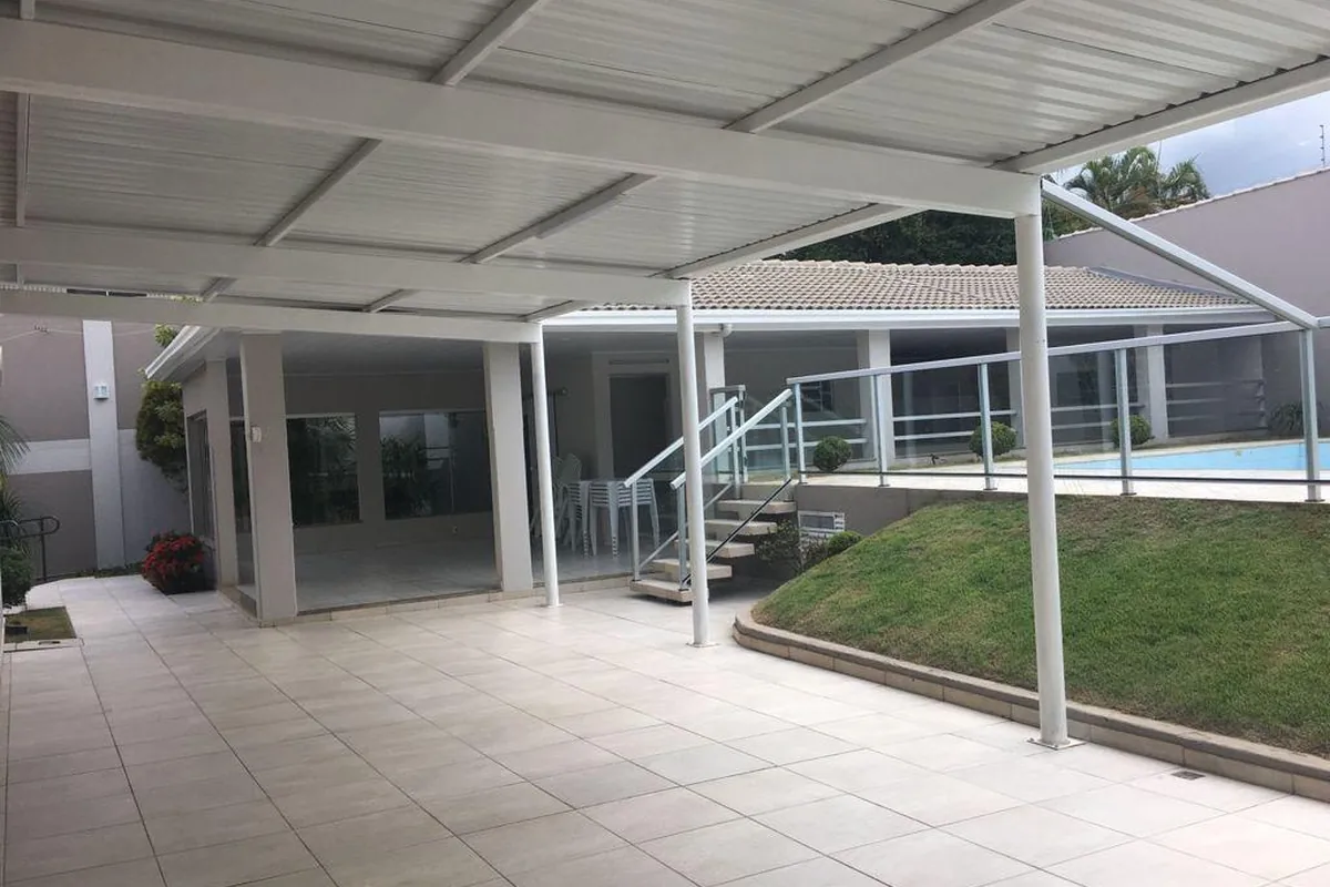 Pátio coberto com área gramada ao lado